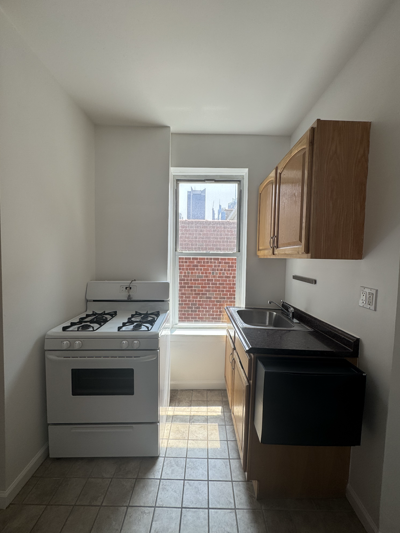 451 West 44th Street, Unit 63 Manhattan, NY 10036 - Photo 6 of 33 a kitchen with a stove and a sink