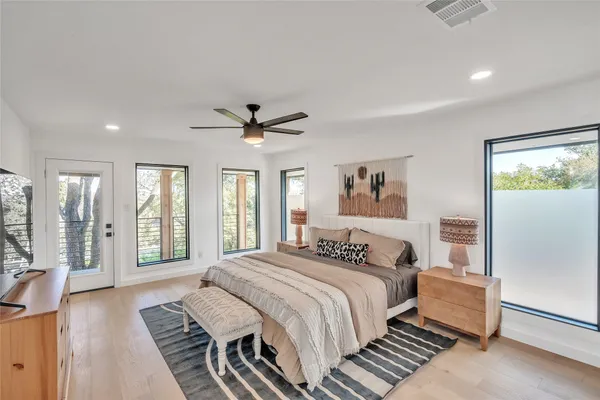 a bedroom with a large bed and a chandelier