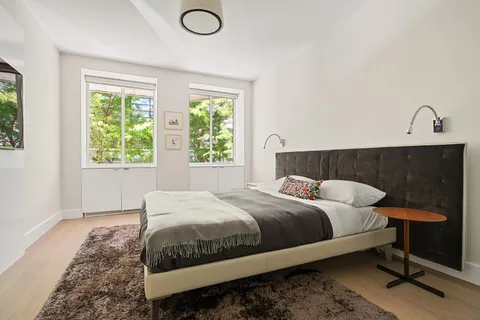 a bedroom with a bed and window