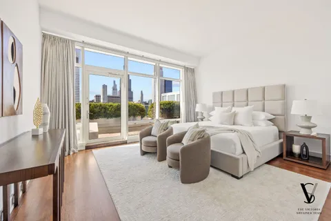 a bedroom with bed and a large window