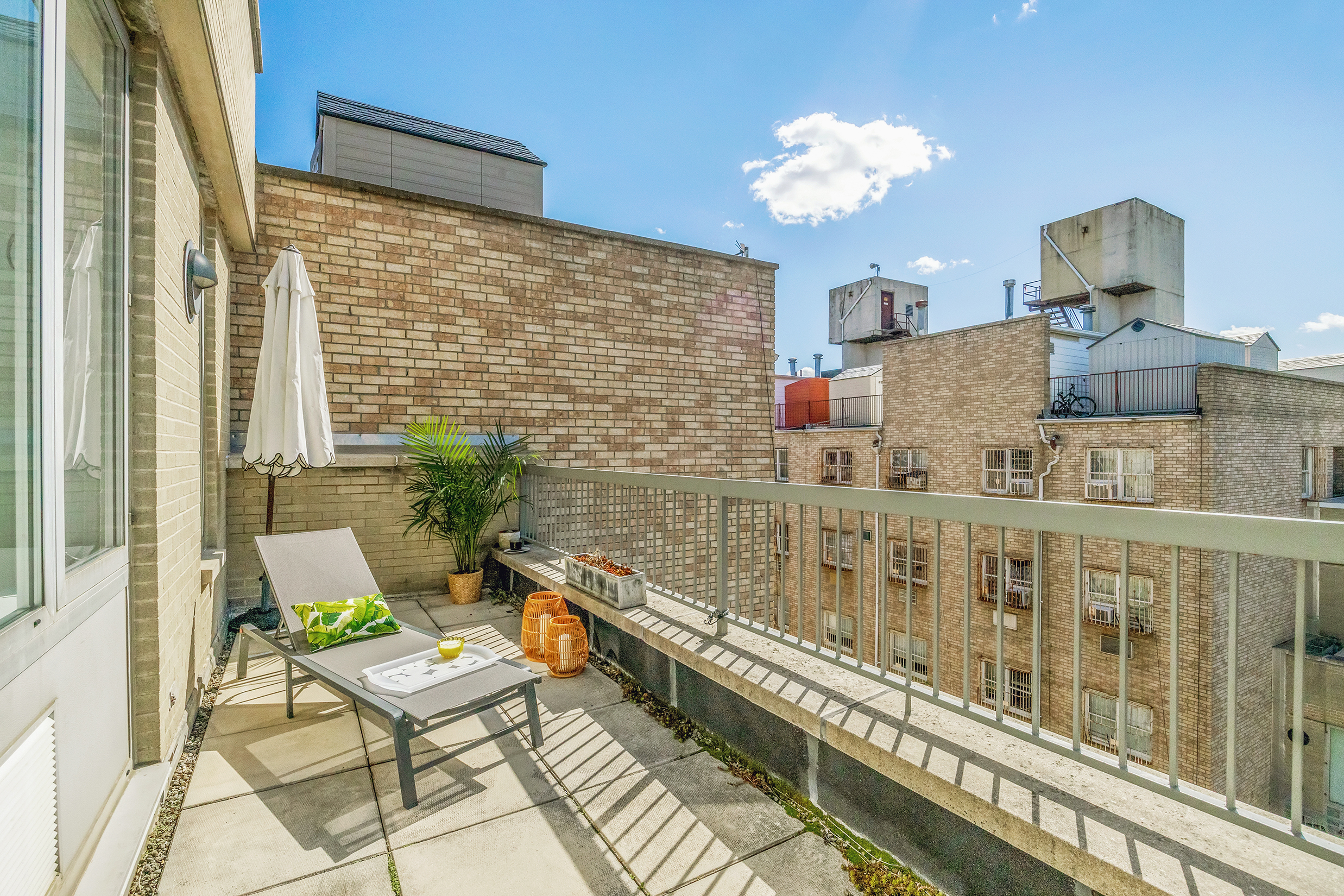 26 Broadway, Unit 704 Brooklyn, NY 11249 - Photo 6 of 20 a balcony with table and chairs