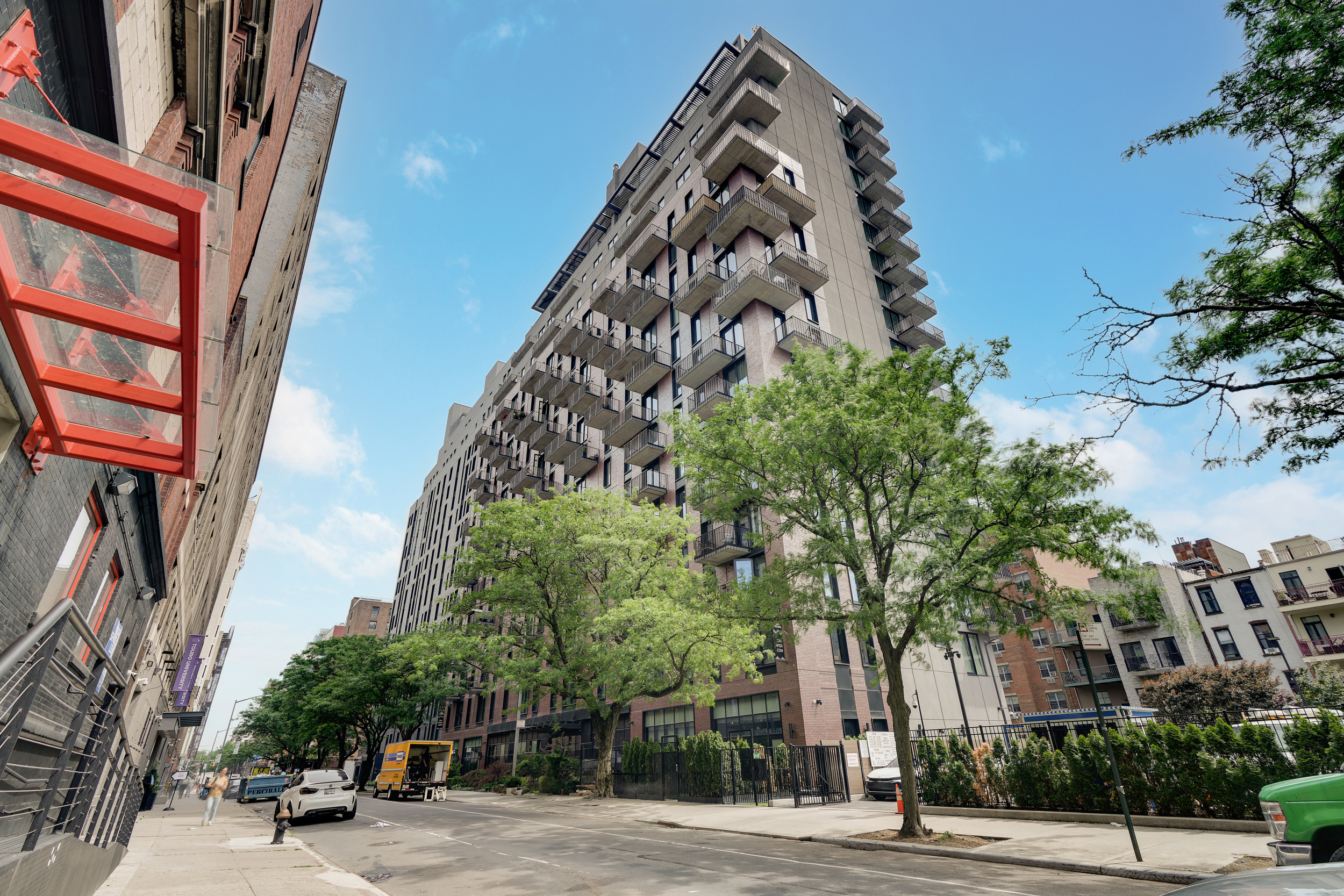 224 West 124th Street, Unit 1501 Manhattan, NY 10027 - Photo 22 of 23 a view of a tall building next to a road