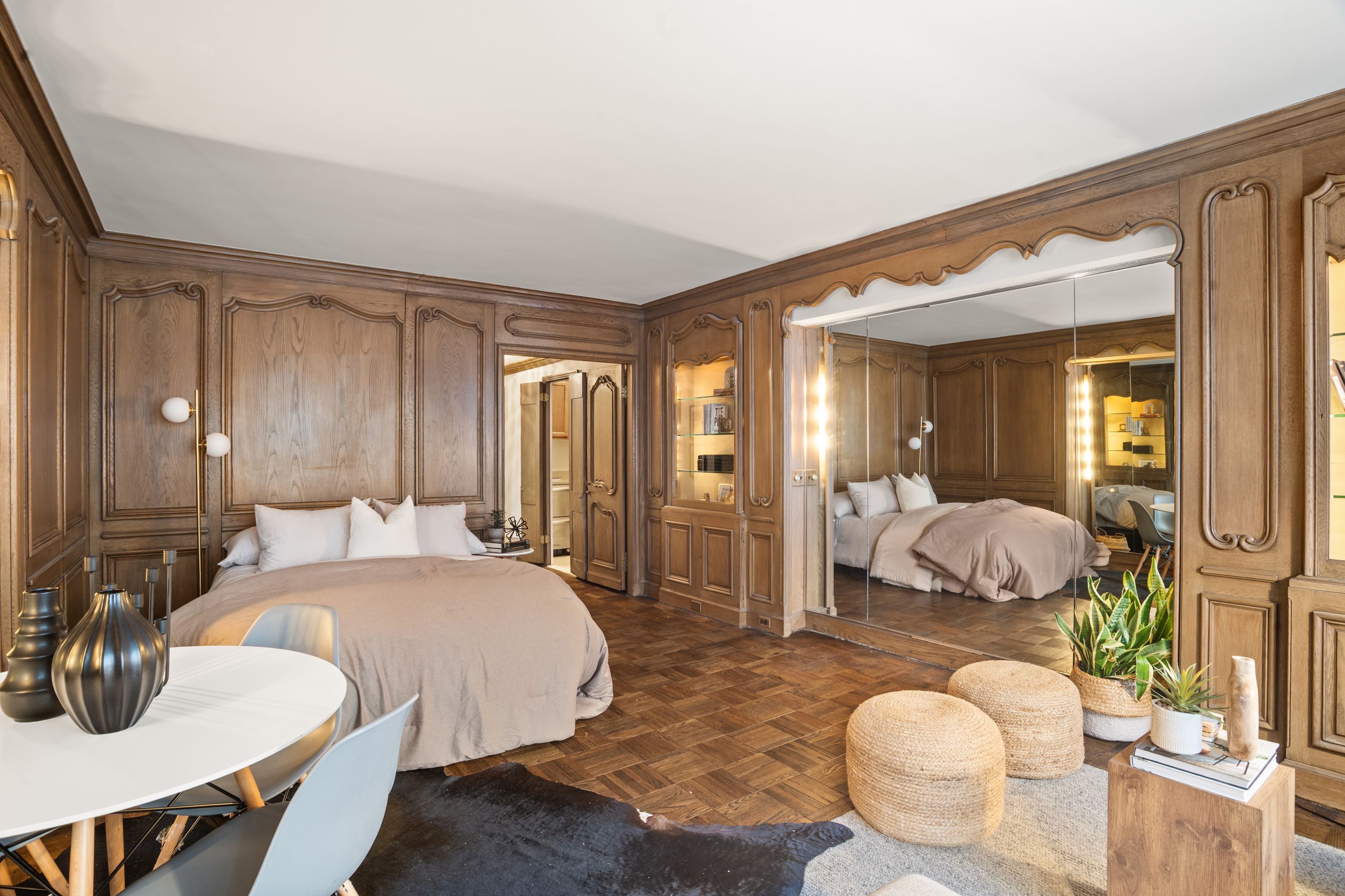 110 East 57th Street, Unit 16B Manhattan, NY 10022 - Photo 8 of 15 a large bedroom with bed and wooden floor