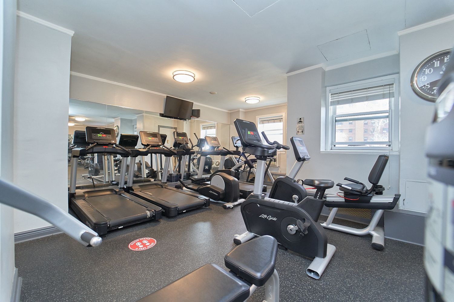 a room with gym equipment and windows