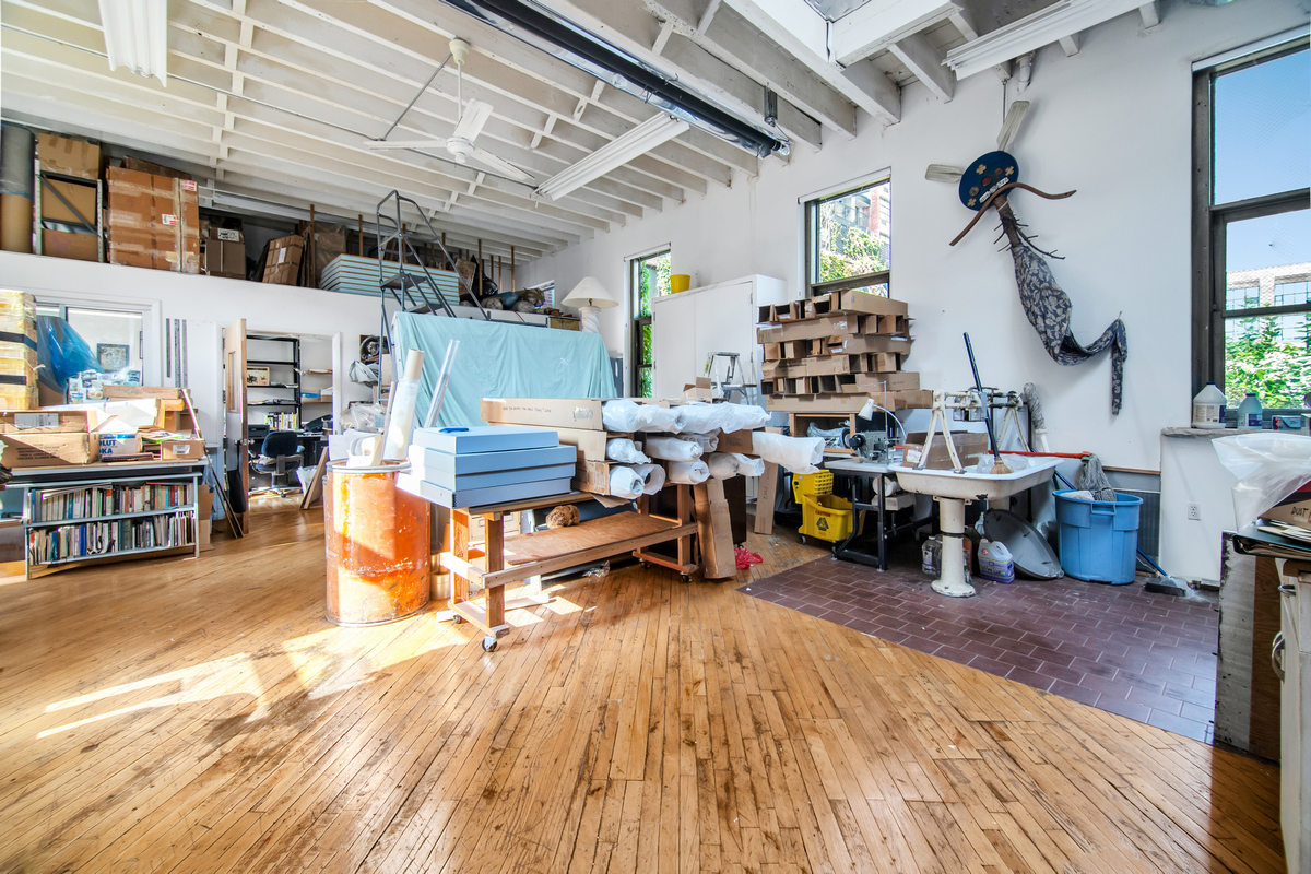5-38 47th Road Queens, NY 11101 - Photo 3 of 14 a living room filled with lots of furniture and a chandelier