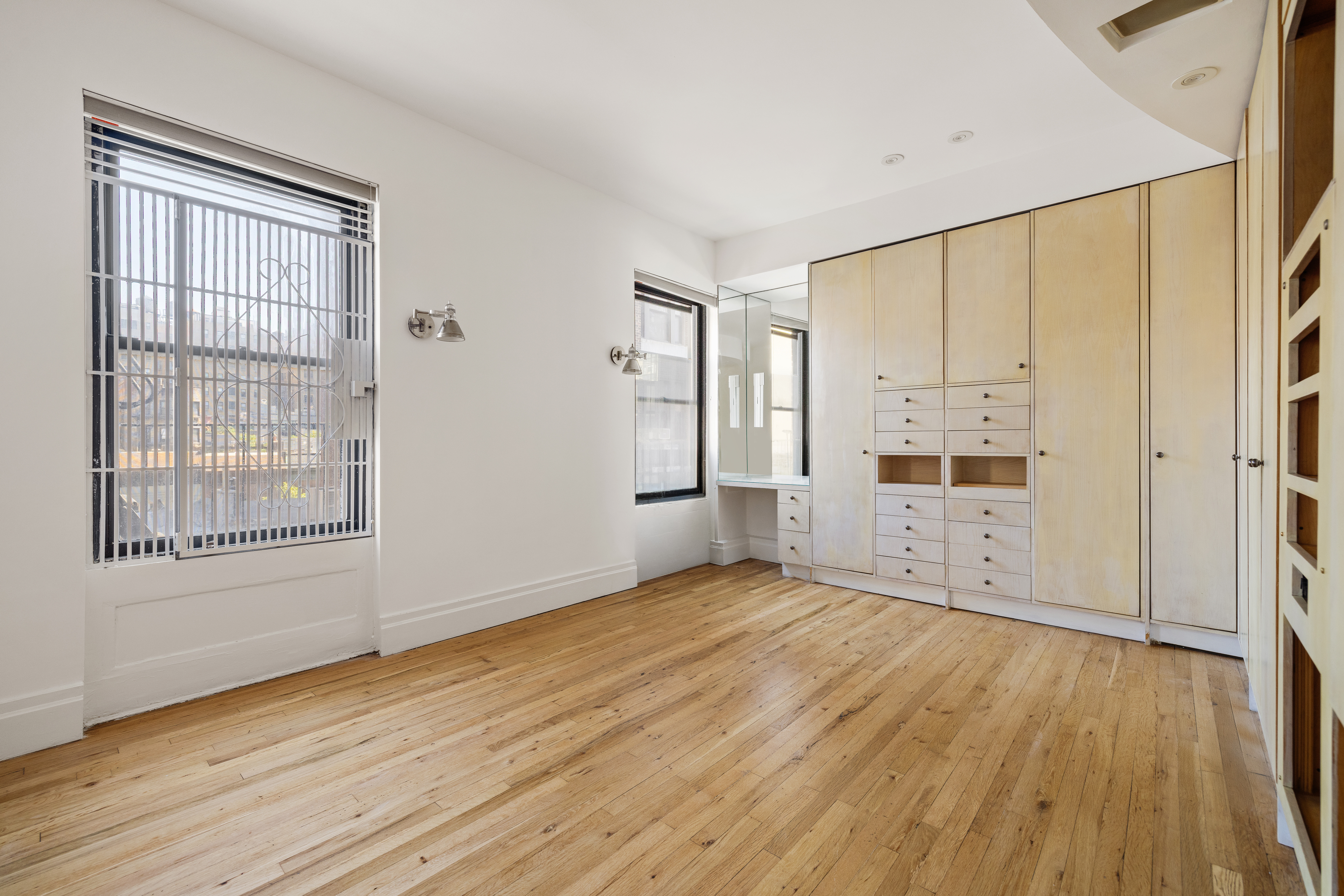 327 West 83rd Street, Unit 6B Manhattan, NY 10024 - Photo 9 of 13 an empty room with wooden floor and windows