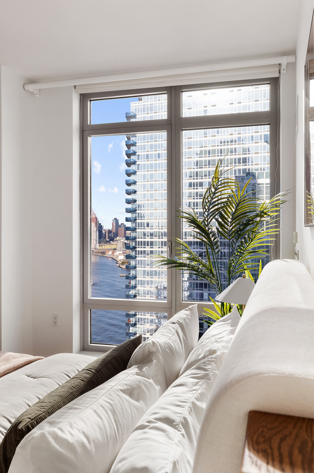 2 Northside Piers, Unit 25P Brooklyn, NY 11249 - Photo 15 of 26 a bedroom with a bed and a large window