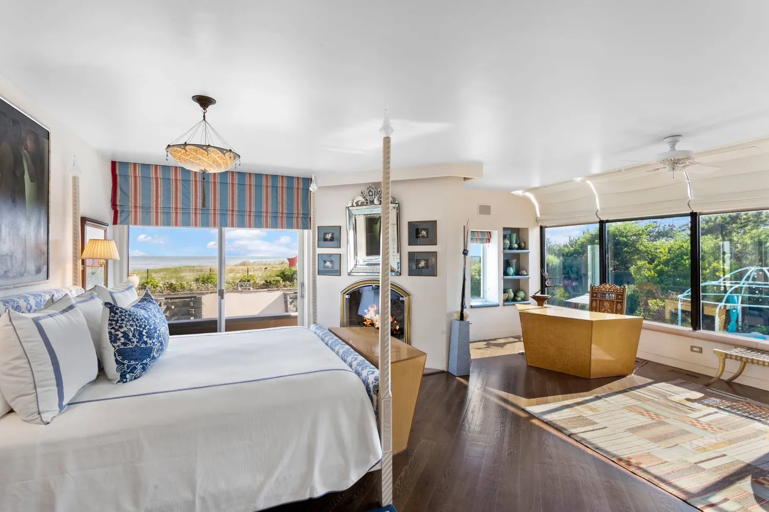 a living room with furniture fireplace and a large window