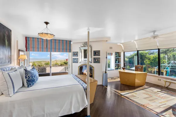 a living room with furniture fireplace and a large window