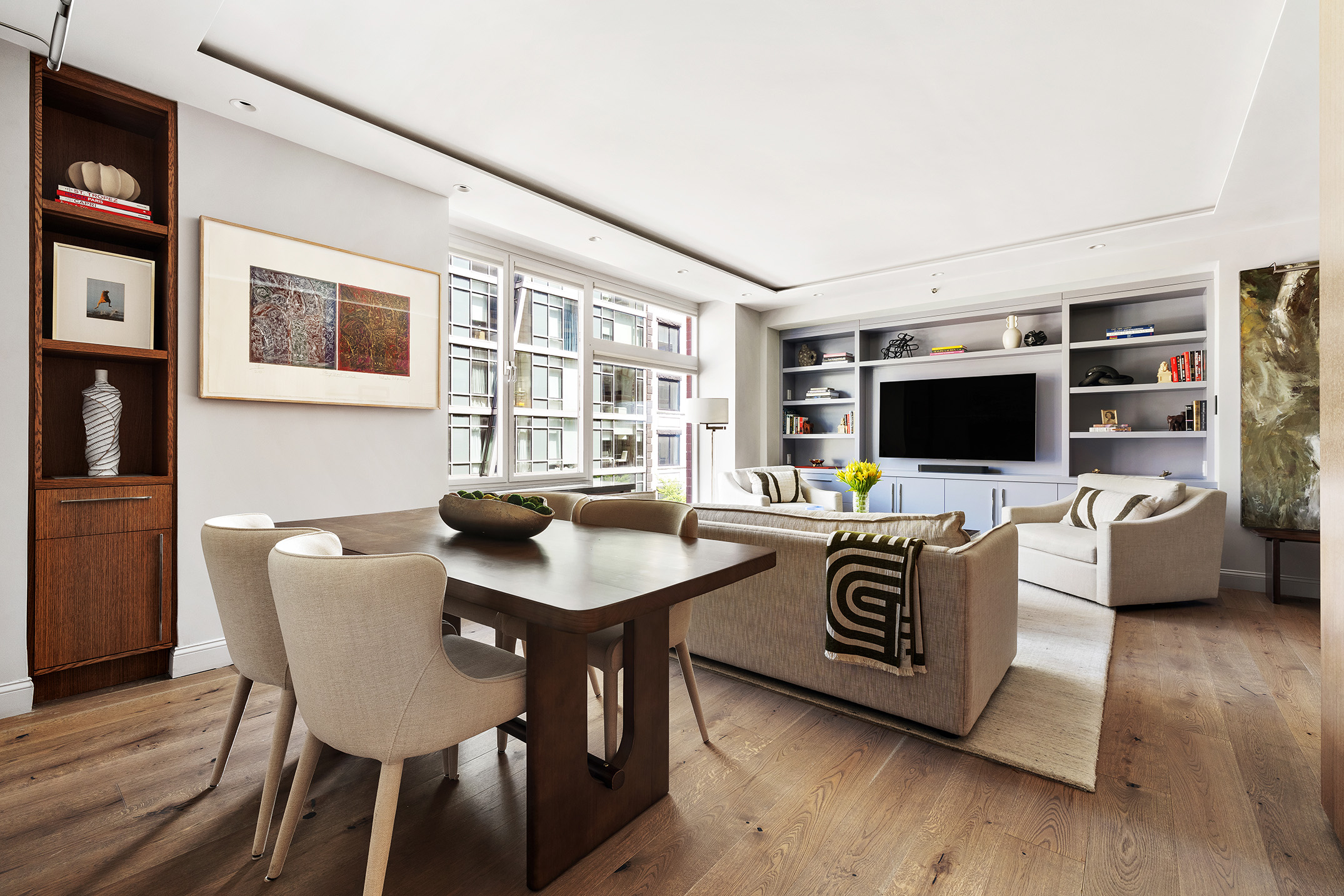 151 West 17th Street, Unit 4G Manhattan, NY 10011 - Photo 4 of 14 a living room with furniture and a flat screen tv