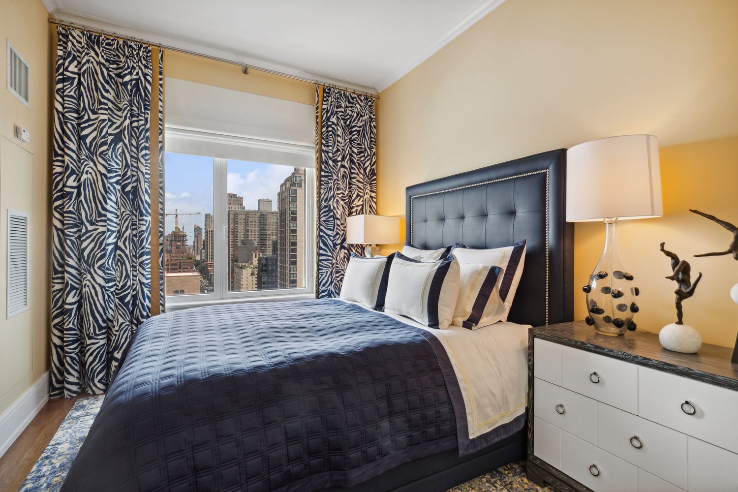 255 East 74th Street, Unit 20C Manhattan, NY 10021 - Photo 11 of 16 a bedroom with a large bed and a window
