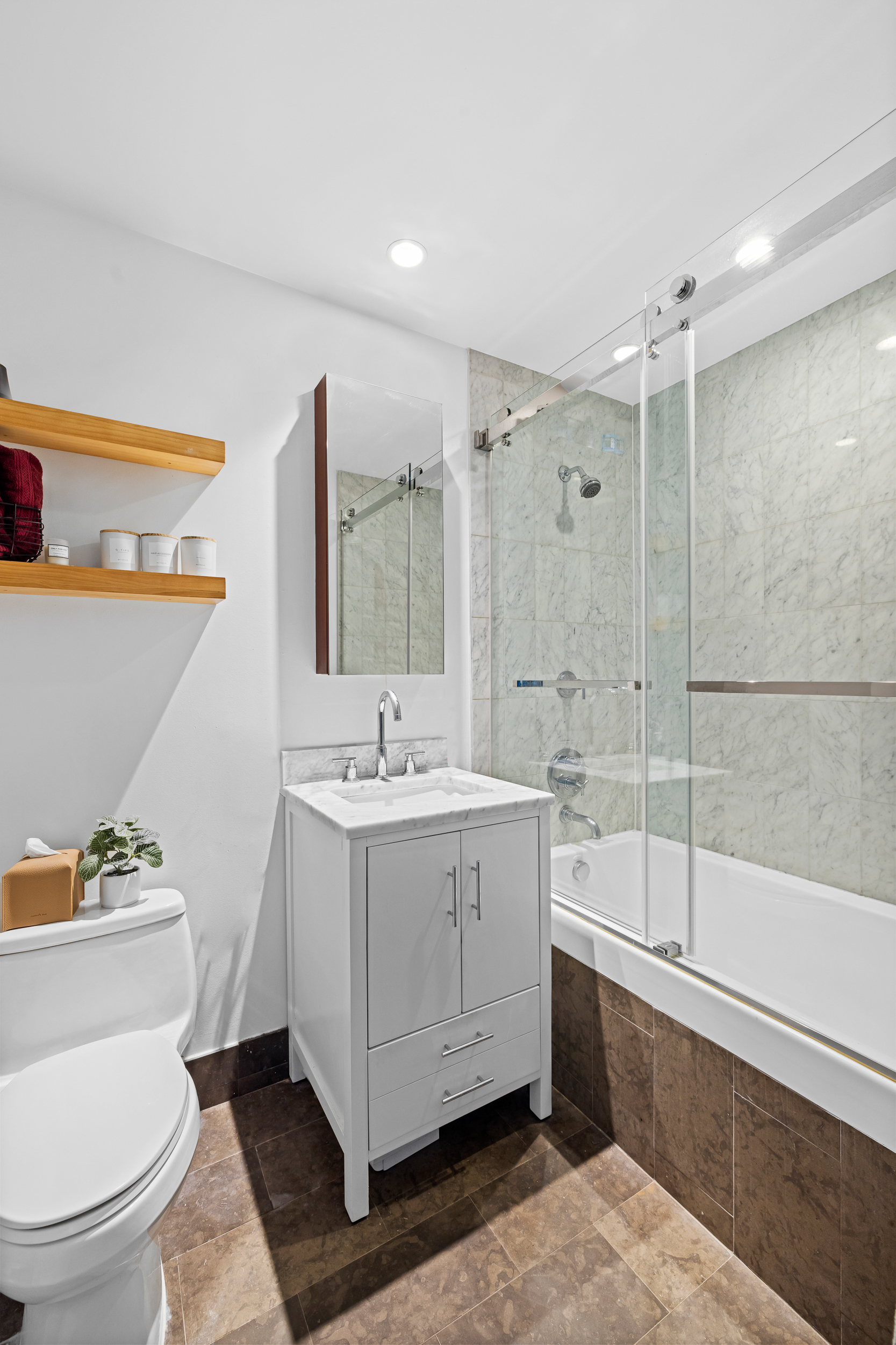100 Jay Street, Unit 12K Brooklyn, NY 11201 - Photo 7 of 14 a bathroom with a sink a toilet and shower