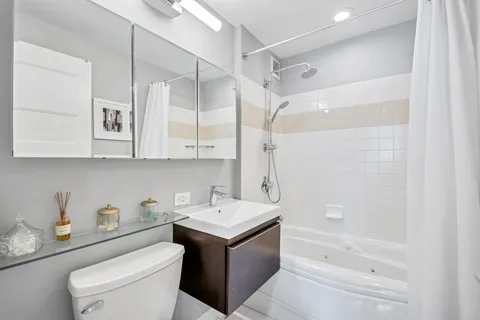 a bathroom with a sink a toilet and a bathtub