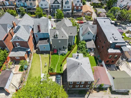 an aerial view of residential houses with outdoor space