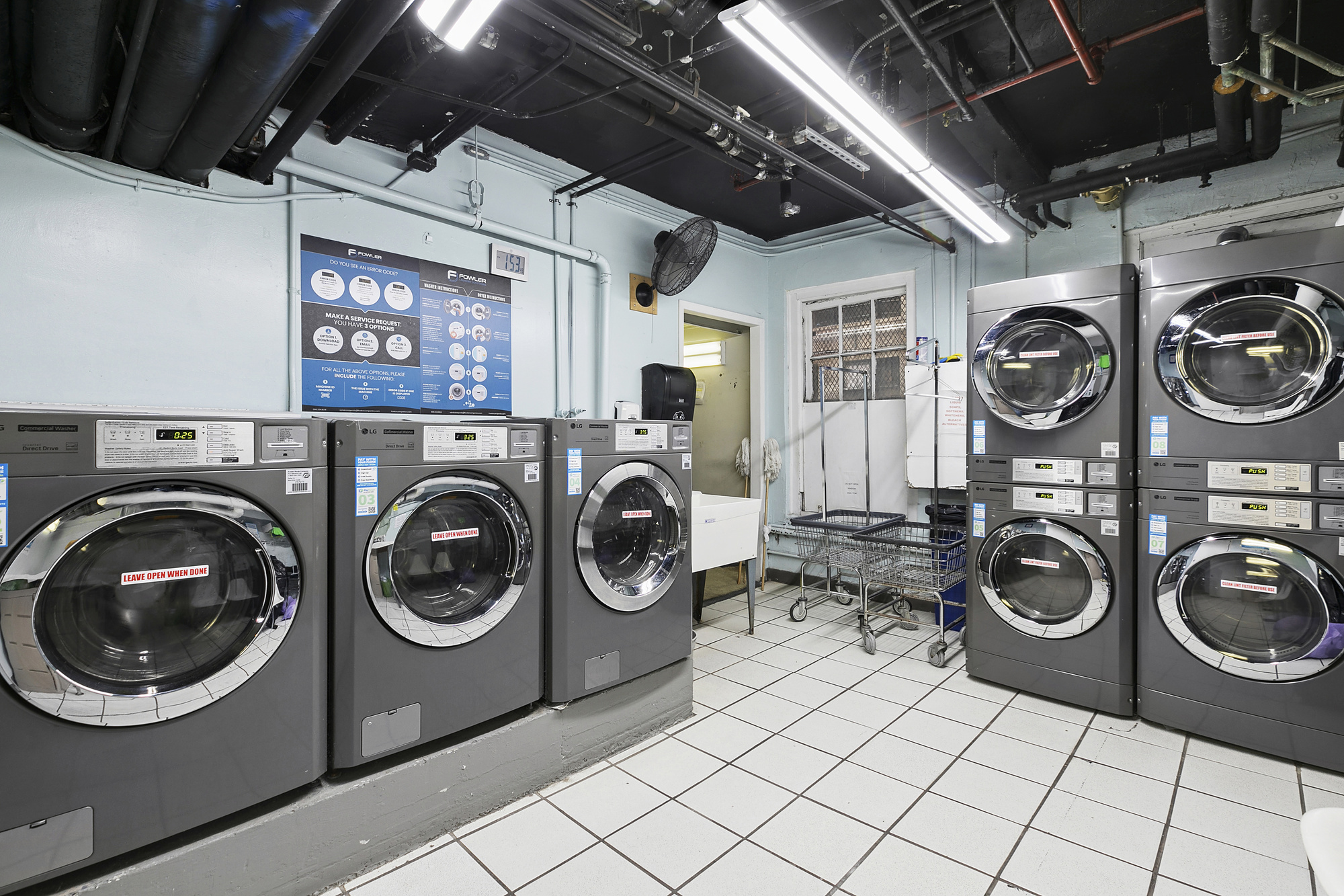 575 Park Avenue, Unit 1403 Manhattan, NY 10065 - Photo 14 of 15 a utility room with dryer washer and a washer