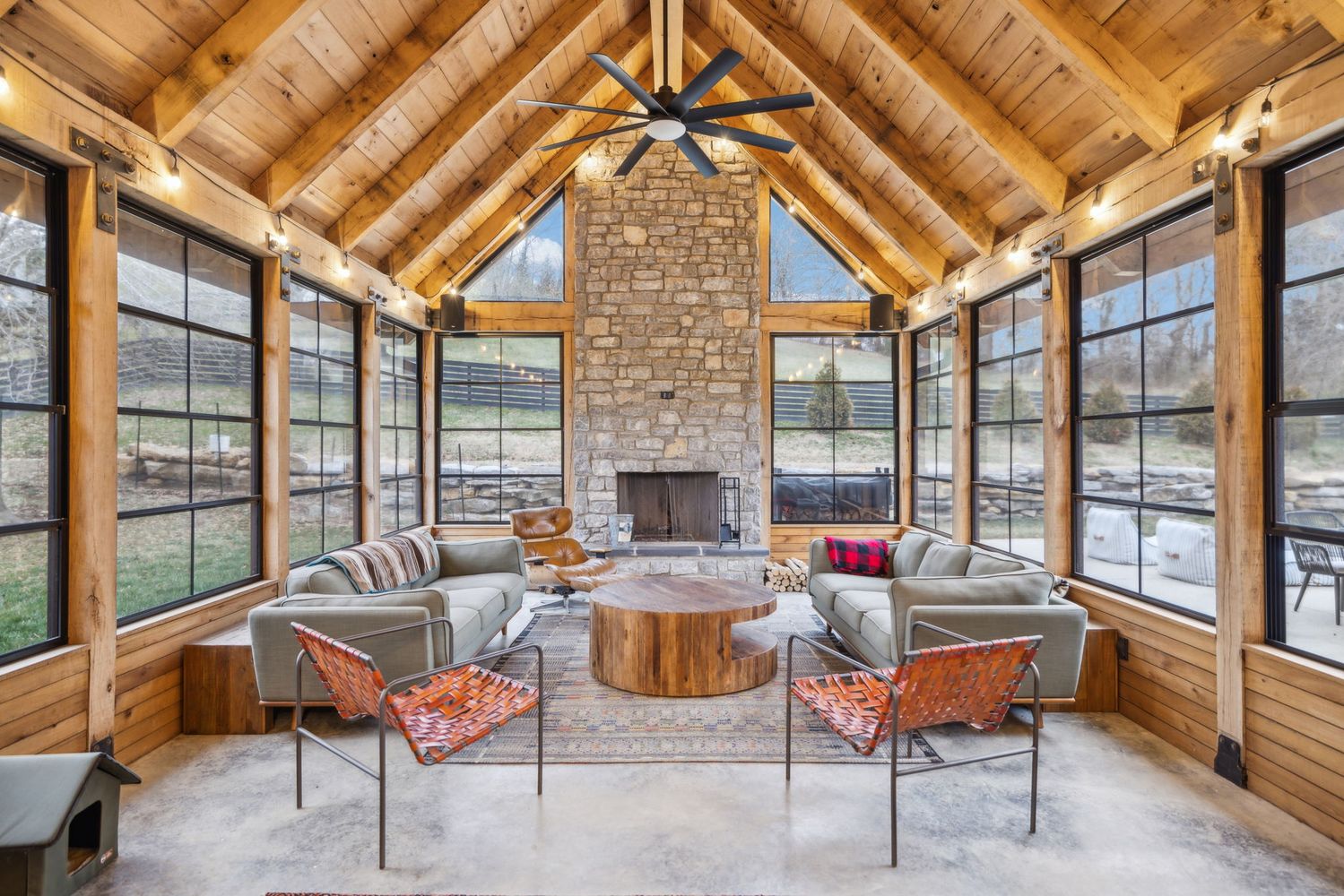 a dining room with furniture and a floor to ceiling window