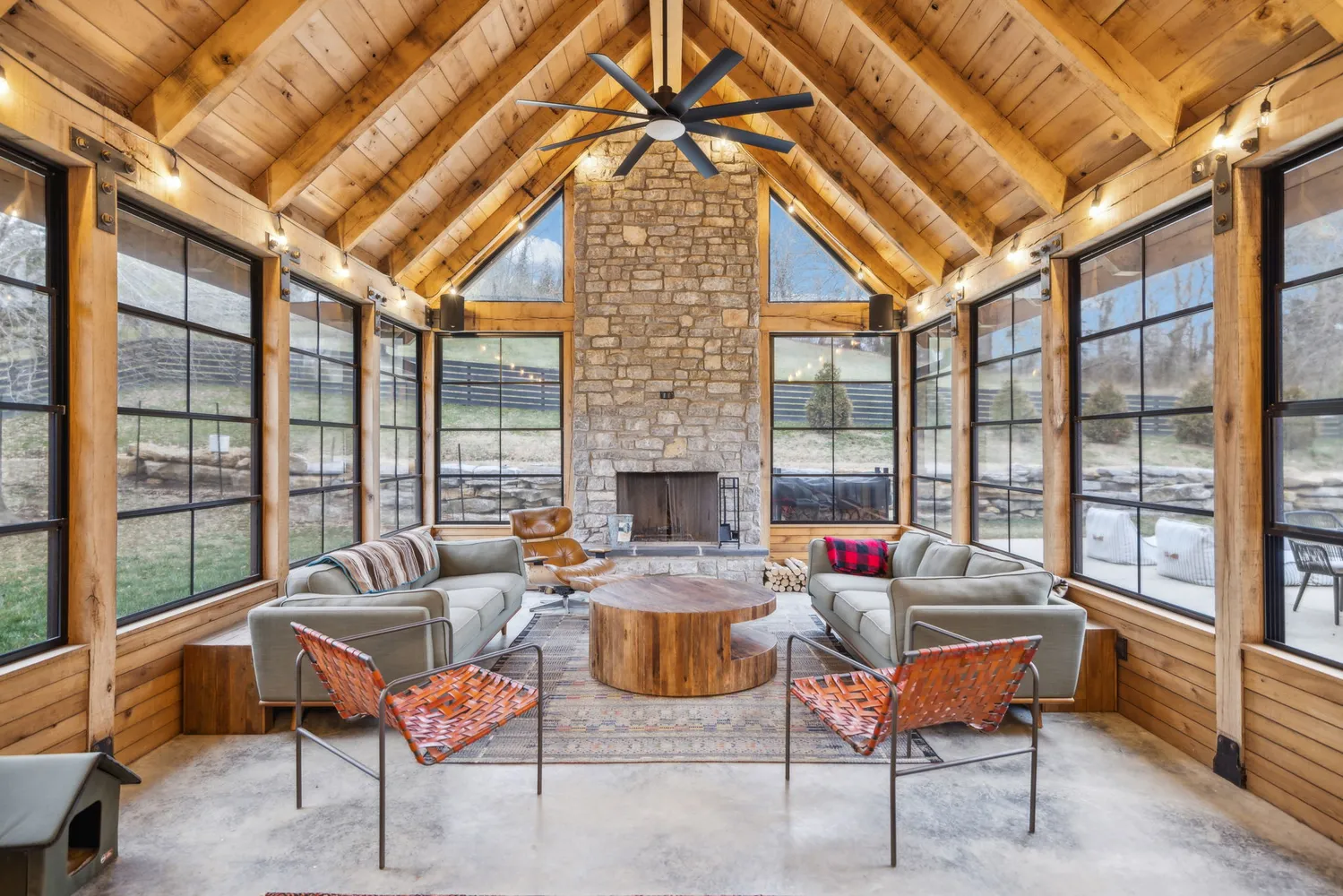 a dining room with furniture and a floor to ceiling window