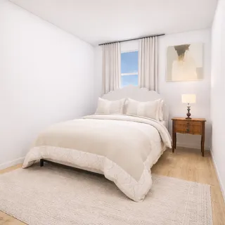 a bedroom with a bed and a couch