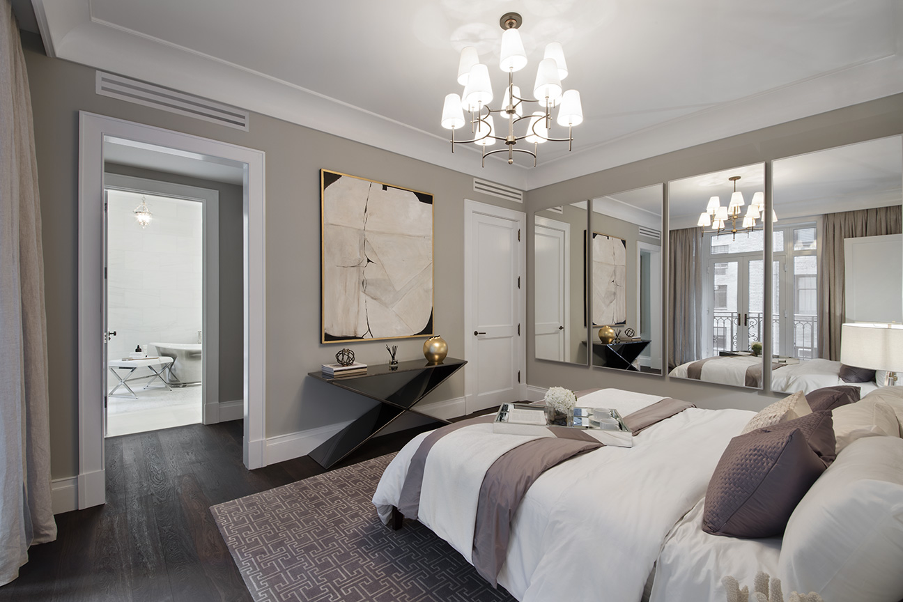 1110 Park Avenue, Unit C Manhattan, NY 10128 - Photo 5 of 9 a spacious bedroom with a bed a chandelier and wooden floor