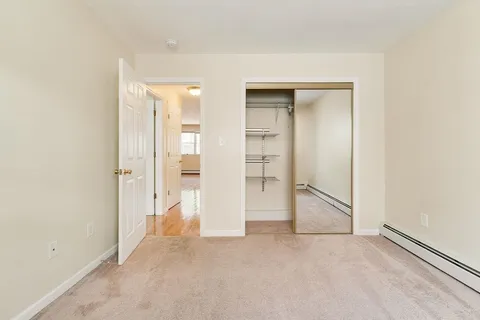 an empty room with a bathroom and a sink