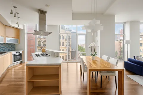 a living room with stainless steel appliances kitchen island granite countertop furniture and a kitchen view