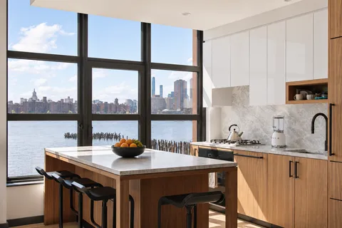 a kitchen with a sink a stove and a window