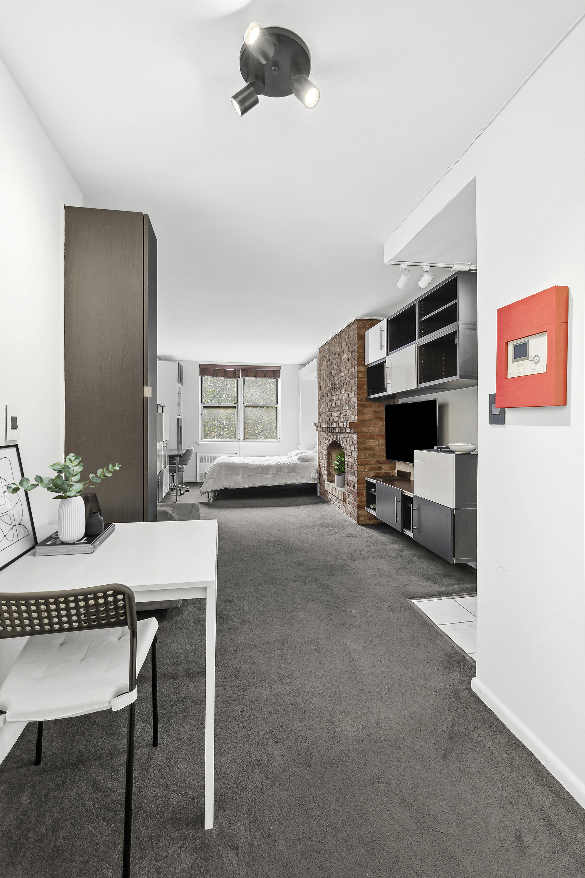 314 West 56th Street, Unit 4E Manhattan, NY 10019 - Photo 8 of 11 a living room with furniture and a flat screen tv