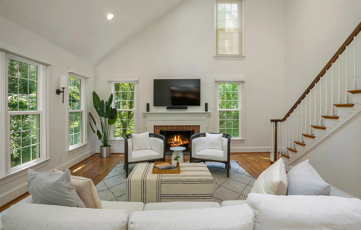 a living room with fireplace furniture and a flat screen tv