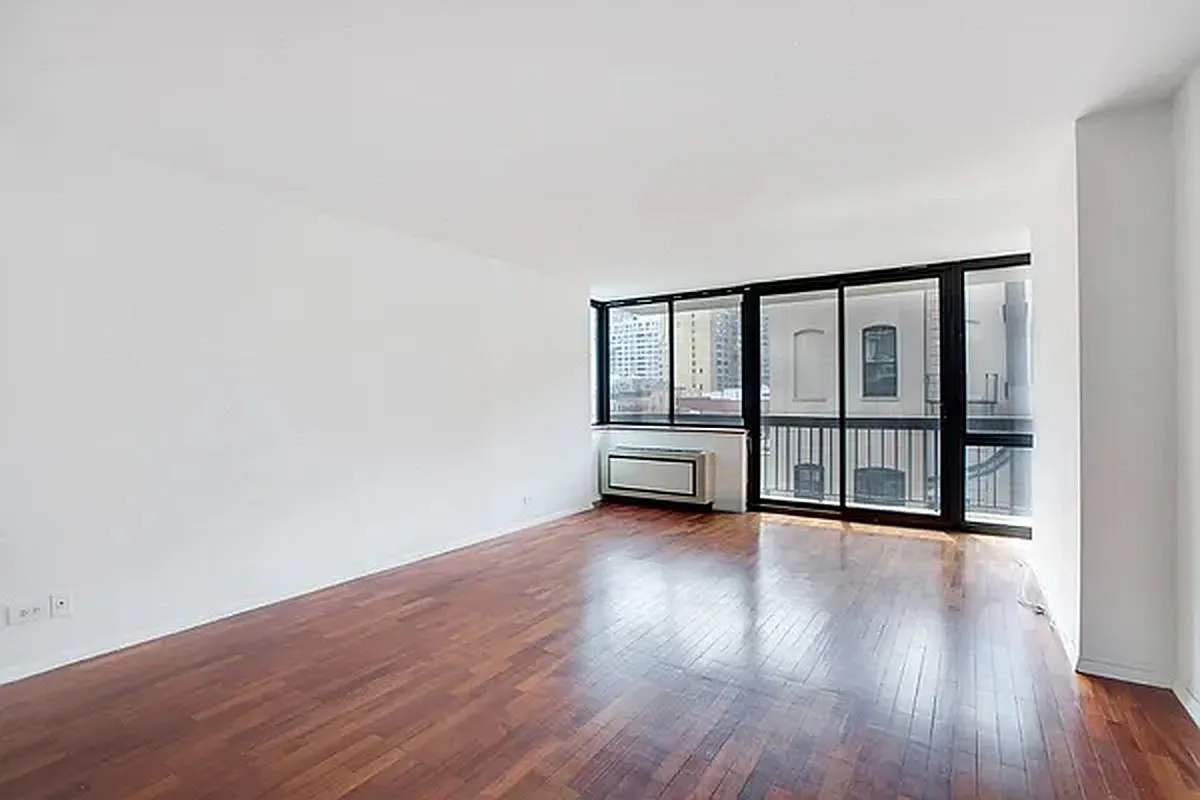 330 East 75th Street, Unit 4D Manhattan, NY 10021 - Photo 2 of 9 a view of an empty room with wooden floor and a window