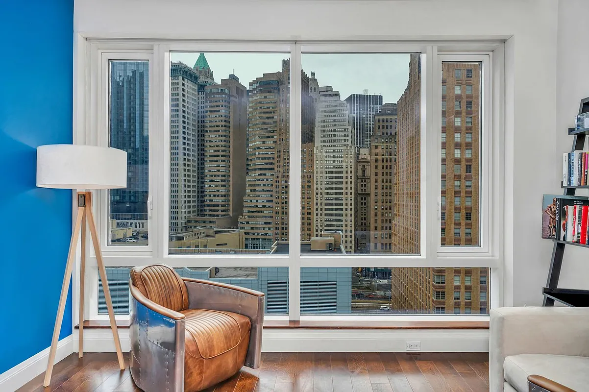 70 Little West Street, Unit 15A Manhattan, NY 10004 - Photo 4 of 19 a view of a balcony with furniture and a large window