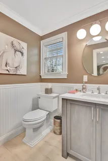 a bathroom with a toilet sink and mirror