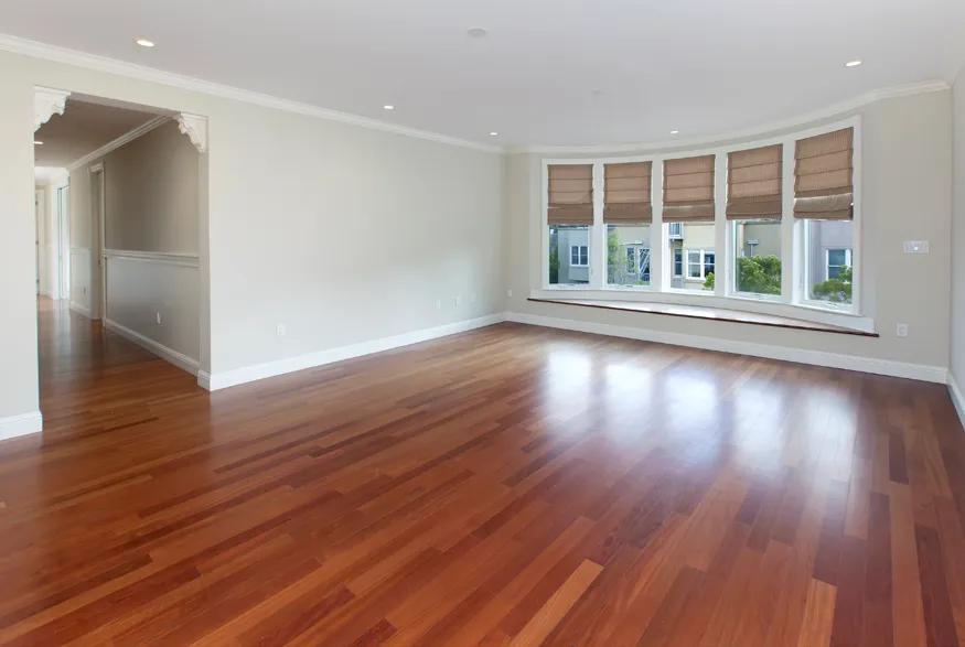 wooden floor in an empty room with a window