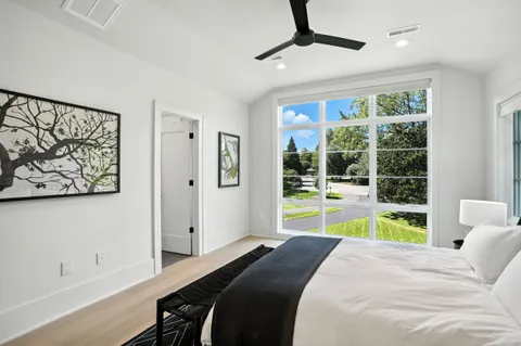 a spacious bedroom with a bed and a ceiling fan