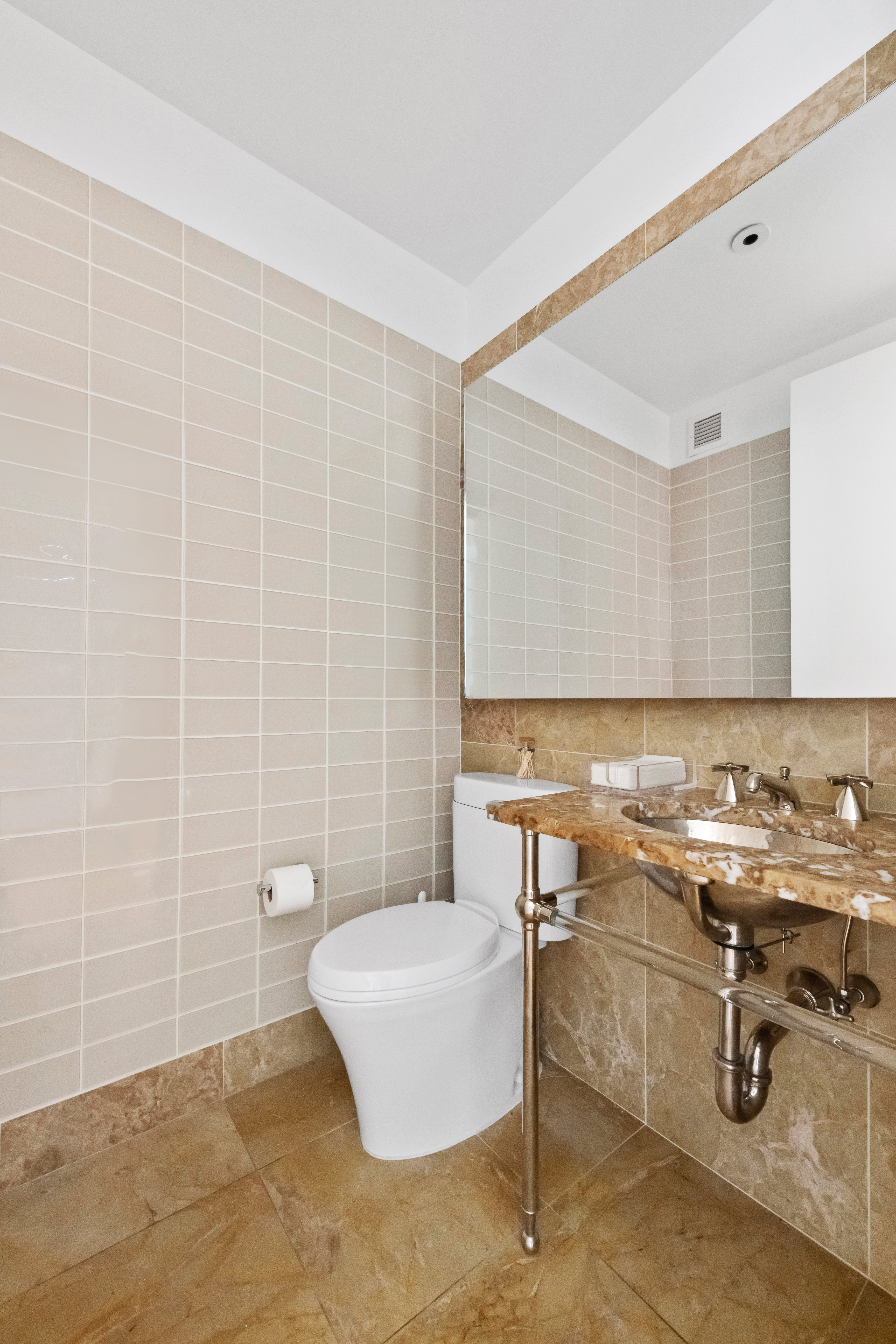 255 East 74th Street, Unit 14C Manhattan, NY 10021 - Photo 13 of 14 a bathroom with a sink a toilet and mirror