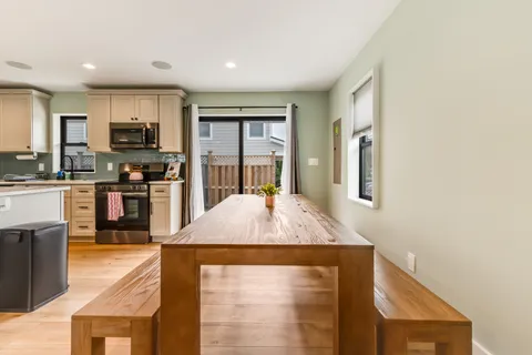 a kitchen with stainless steel appliances granite countertop a stove top oven a sink a counter space and cabinets
