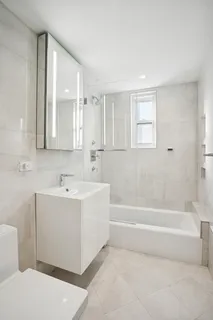 a view of bathroom with bathtub and mirror
