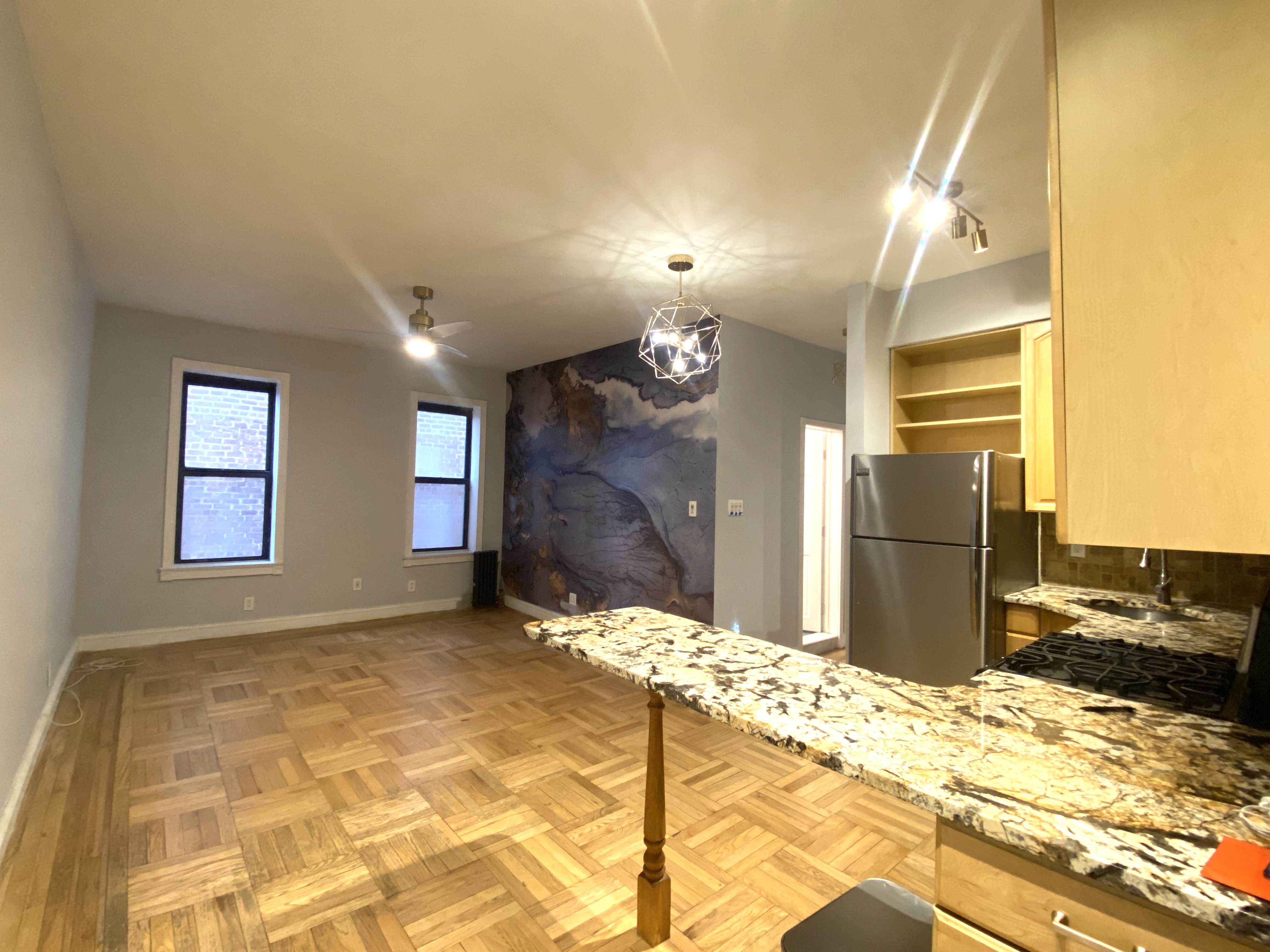 a view of a livingroom with kitchen