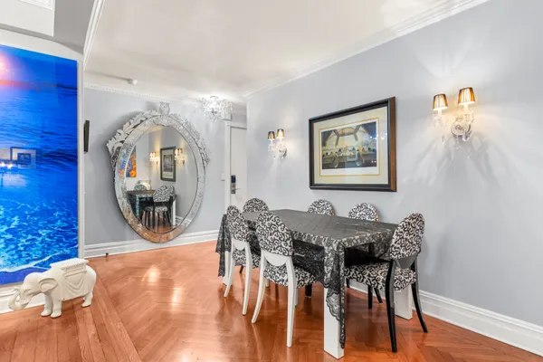 a view of a dining room with furniture and a chandelier