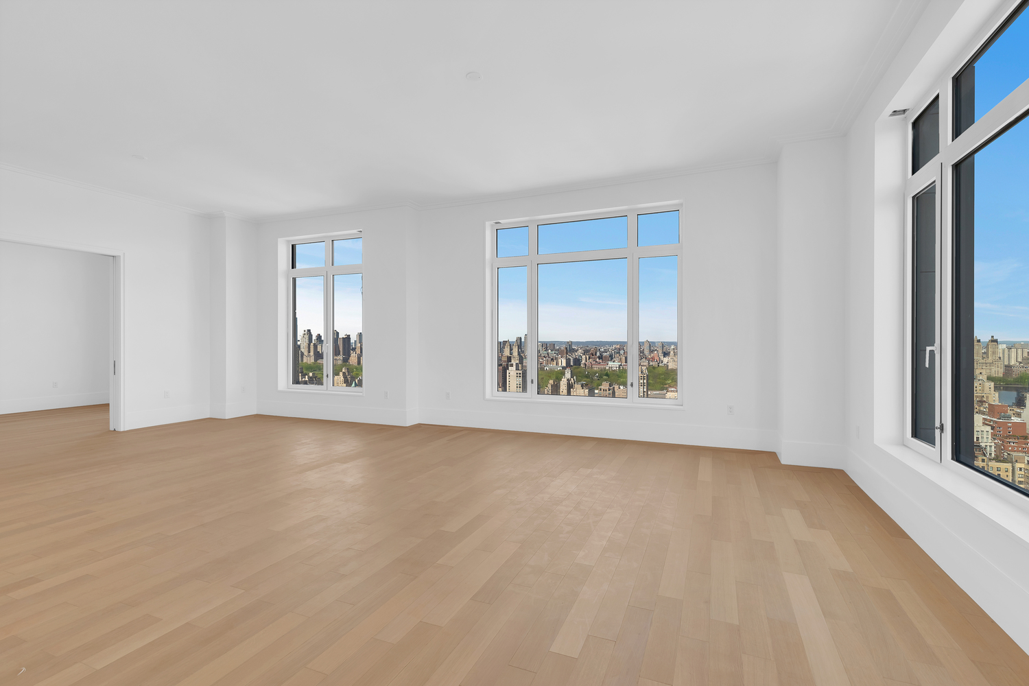 200 East 83rd Street, Unit 34A Manhattan, NY 10028 - Photo 4 of 34 a view of an empty room with window and wooden floor