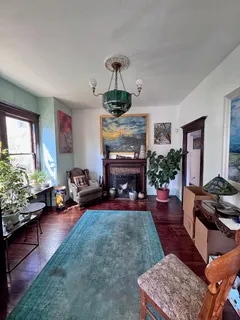a living room with furniture fireplace and a window