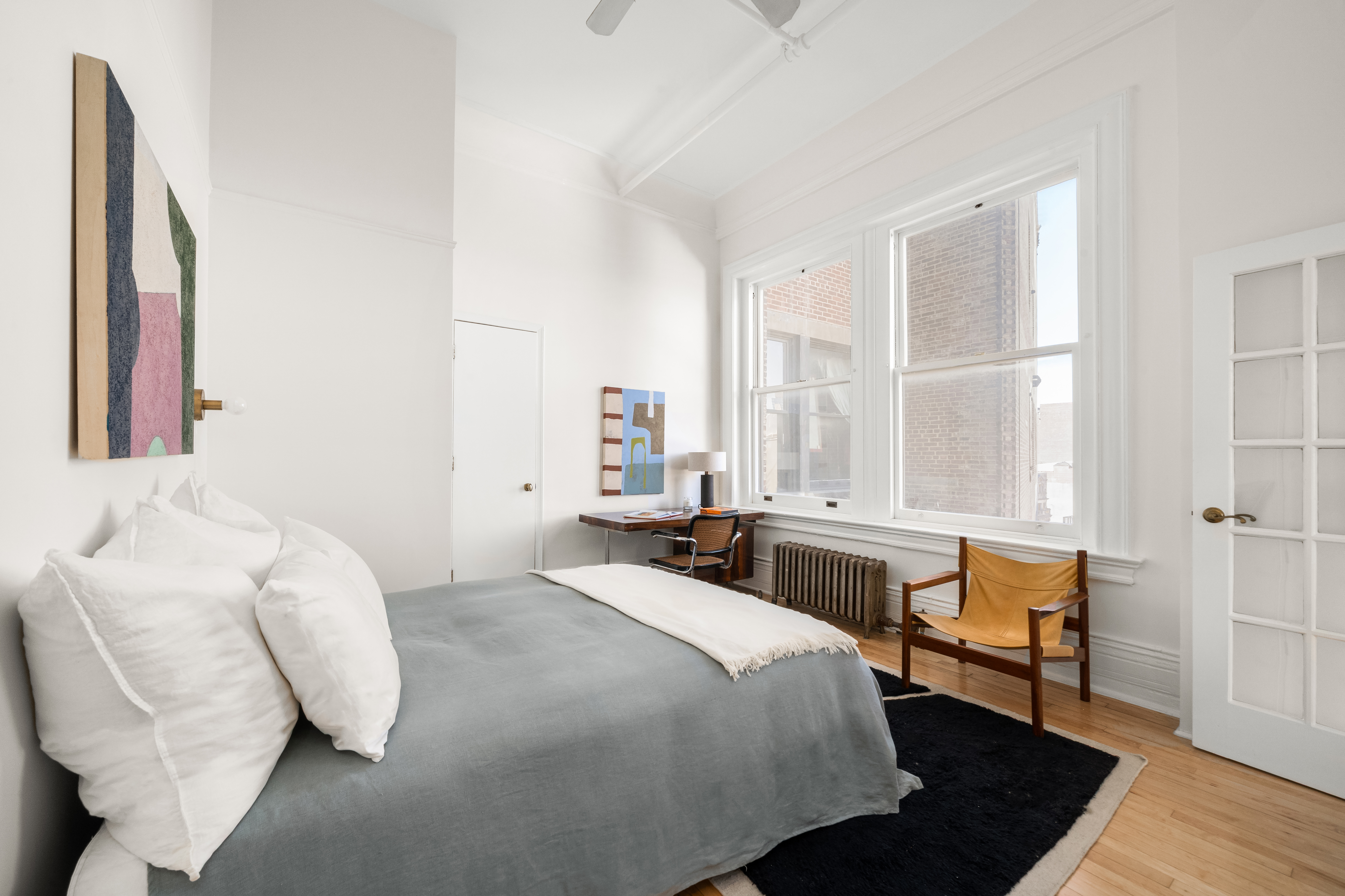 874 Broadway, Unit 907 Manhattan, NY 10003 - Photo 5 of 14 a bedroom with a bed and wooden floor