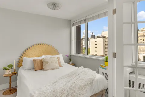 a bedroom with a bed and window