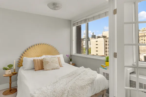 a bedroom with a bed and window