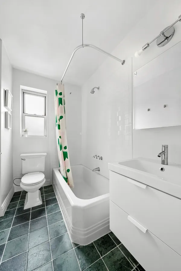 a spacious bathroom with a sink a toilet and a bathtub