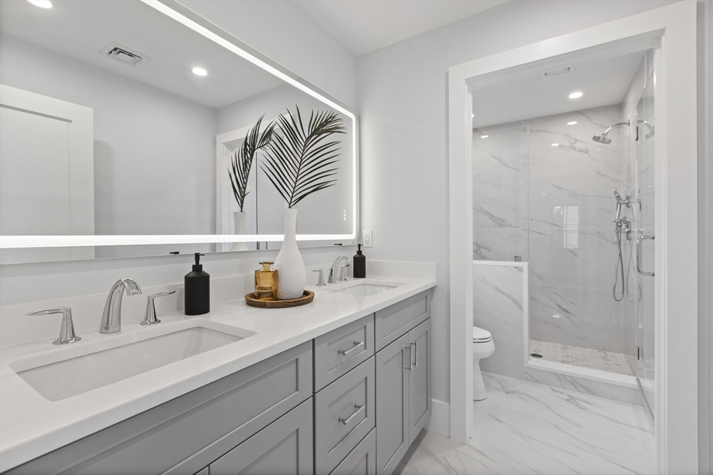 10 Webber Avenue, Unit 3C Bedford, MA 01730 - Photo 13 of 36 a bathroom with a sink a toilet and shower