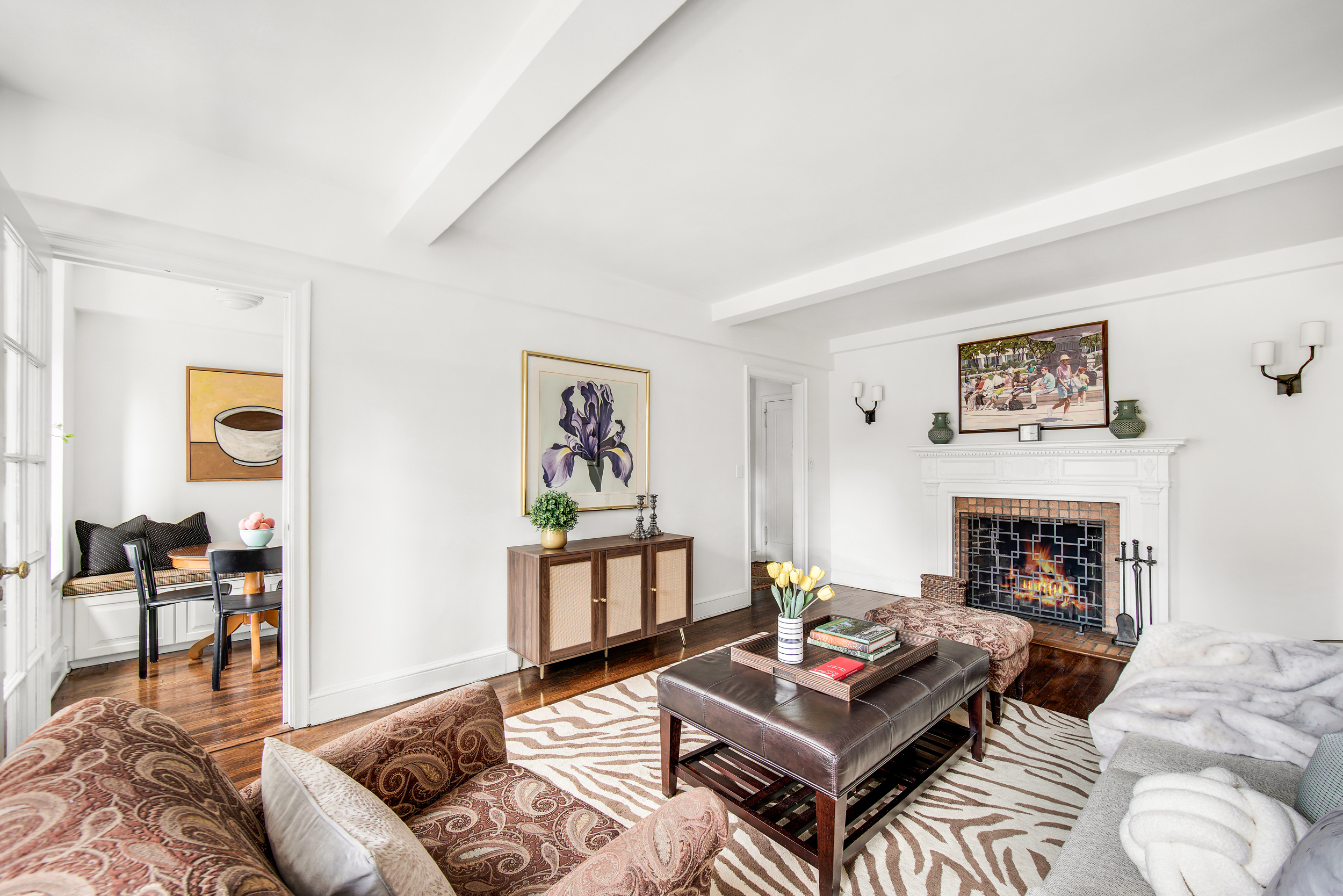 205 East 78th Street, Unit 9F Manhattan, NY 10075 - Photo 2 of 13 a living room with furniture a rug and a fireplace