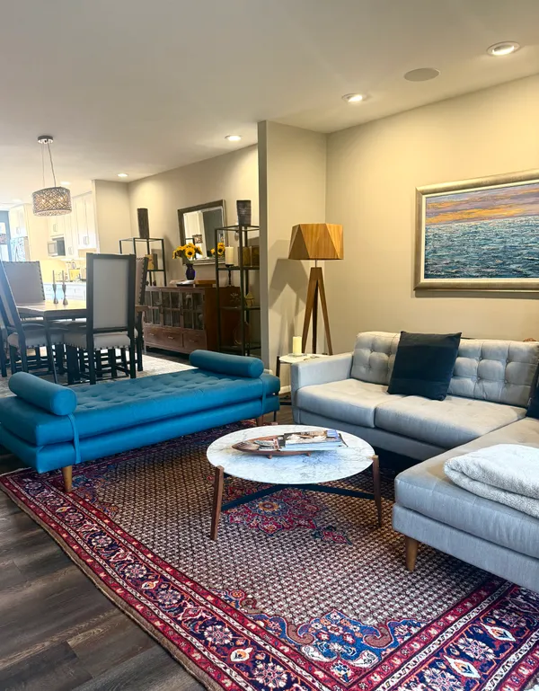 a living room with furniture and wooden floor