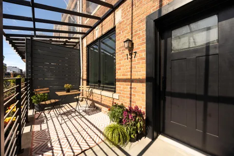 a balcony with wooden floor and outdoor seating