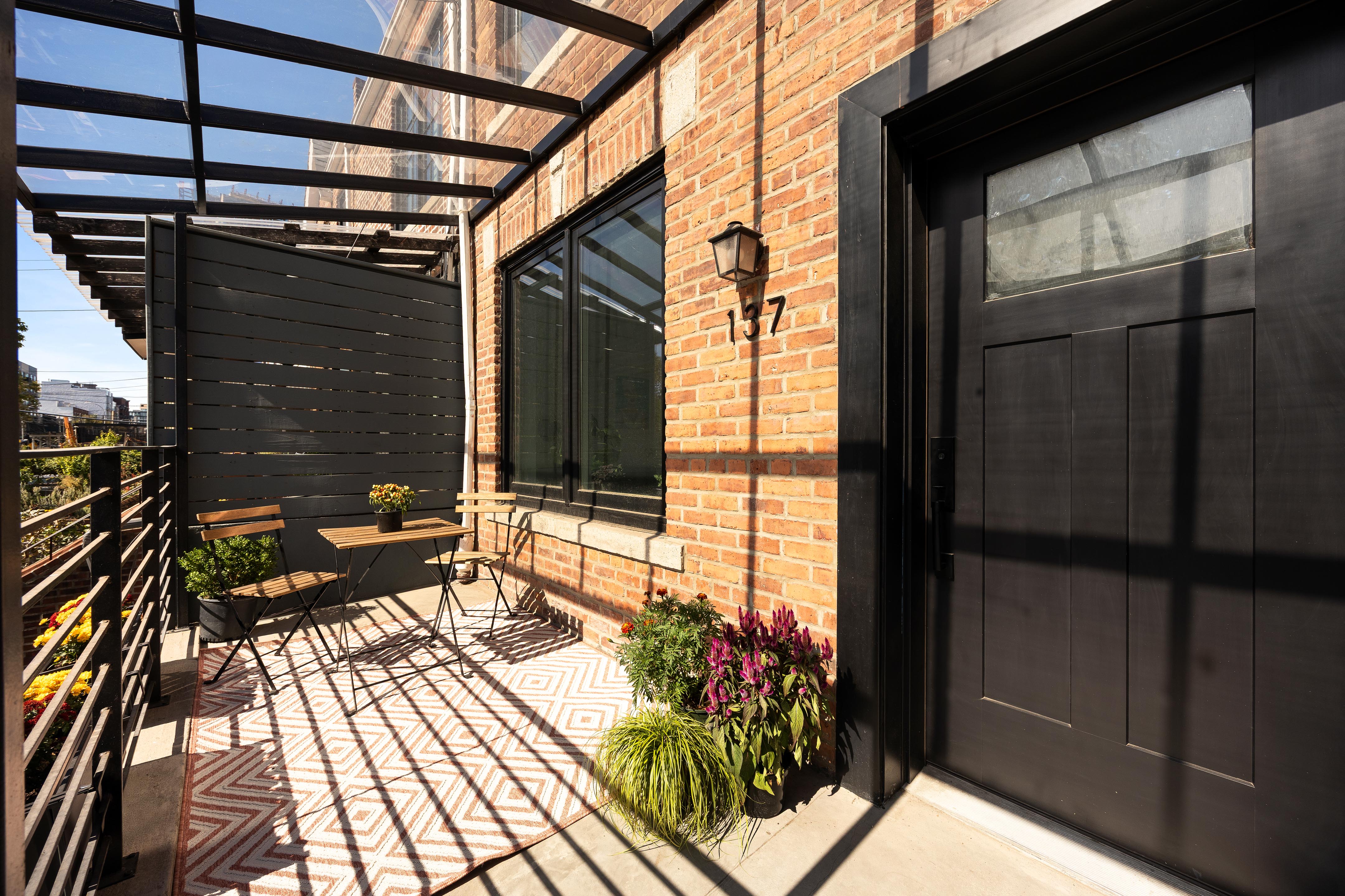 137 Maspeth Avenue Brooklyn, NY 11211 - Photo 3 of 18 a balcony with wooden floor and outdoor seating