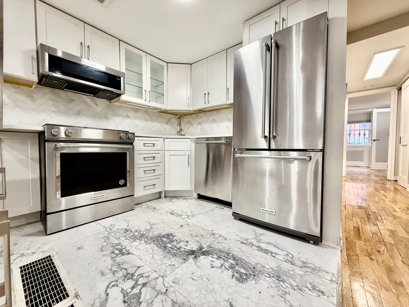 a kitchen with stainless steel appliances granite countertop a stove a microwave and a refrigerator